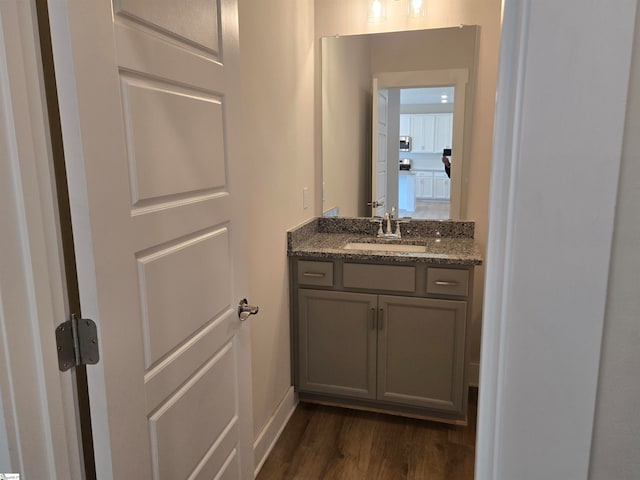 bathroom with hardwood / wood-style floors and vanity