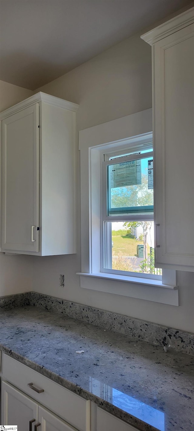 details with light stone counters and white cabinets