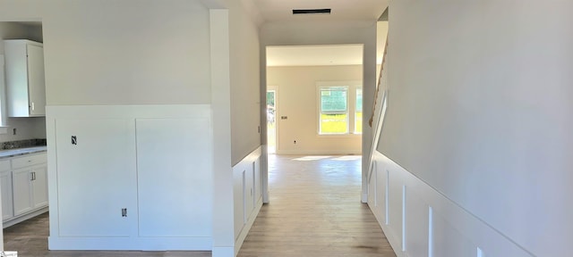 corridor with light wood-type flooring