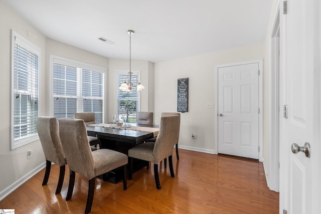 dining space featuring a chandelier and wood-type flooring