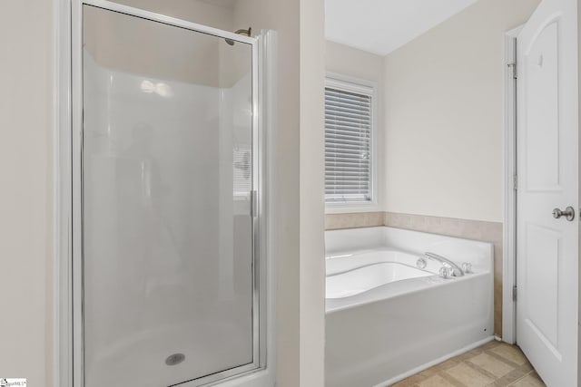 bathroom featuring tile patterned floors and independent shower and bath