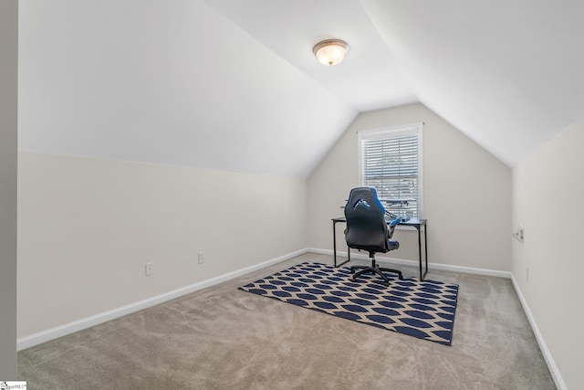 carpeted office featuring vaulted ceiling