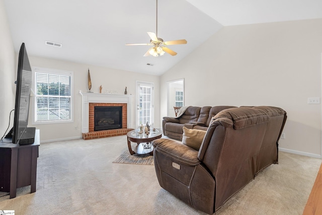 living room featuring ceiling fan, light carpet, high vaulted ceiling, and a brick fireplace