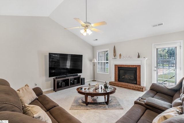 living room featuring a fireplace, light carpet, high vaulted ceiling, and ceiling fan