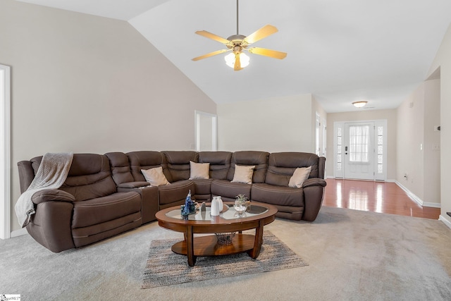 carpeted living room featuring ceiling fan and high vaulted ceiling