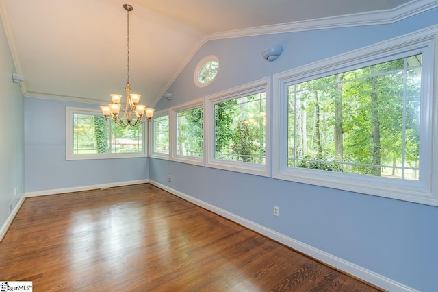 spare room with a notable chandelier, baseboards, vaulted ceiling, and wood finished floors