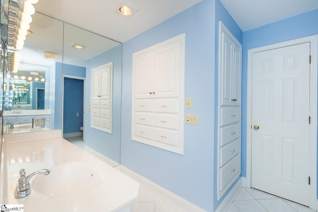 full bathroom with tile patterned flooring, a closet, vanity, and baseboards