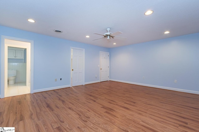 unfurnished room with baseboards, wood finished floors, a ceiling fan, and recessed lighting