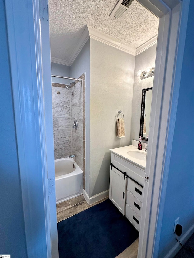 bathroom with ornamental molding, vanity, a textured ceiling, bathing tub / shower combination, and hardwood / wood-style flooring