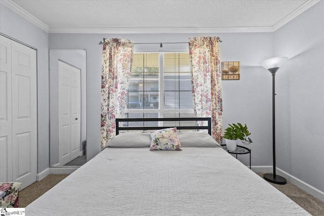 bedroom featuring ornamental molding, a textured ceiling, and dark carpet