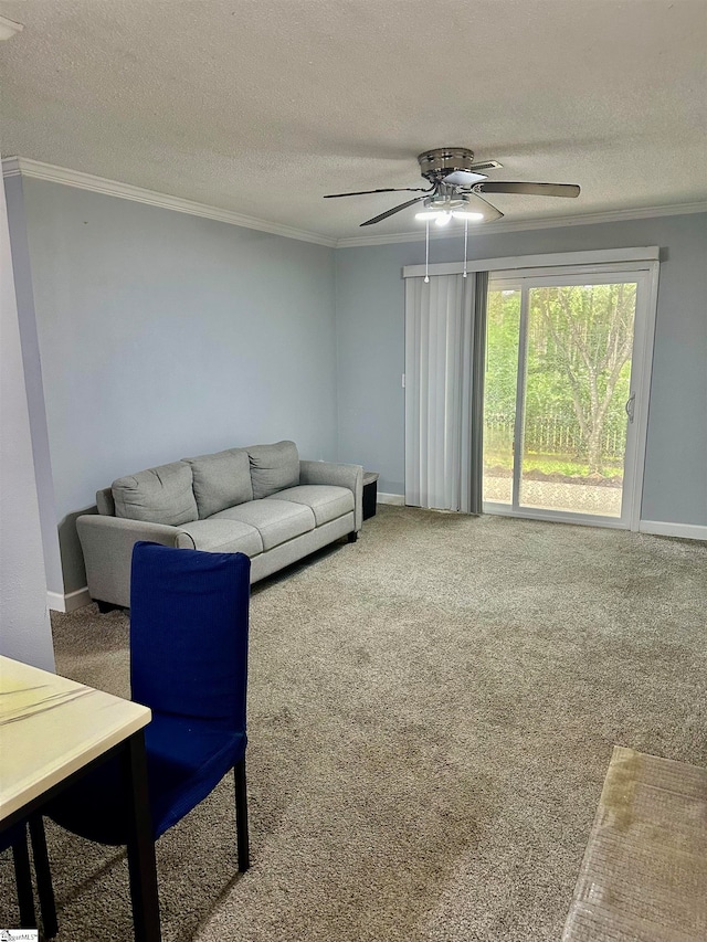 living room with ceiling fan, crown molding, a textured ceiling, and carpet floors