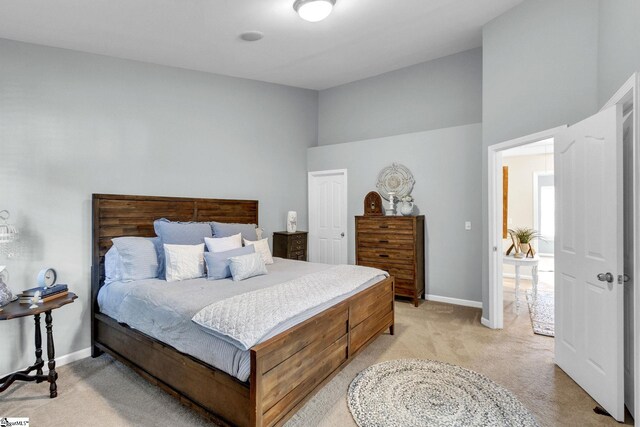 carpeted bedroom featuring a towering ceiling