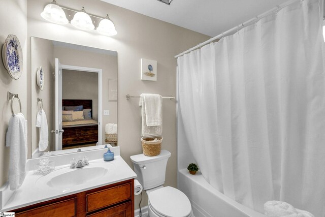 full bathroom with shower / bath combination with curtain, toilet, and vanity