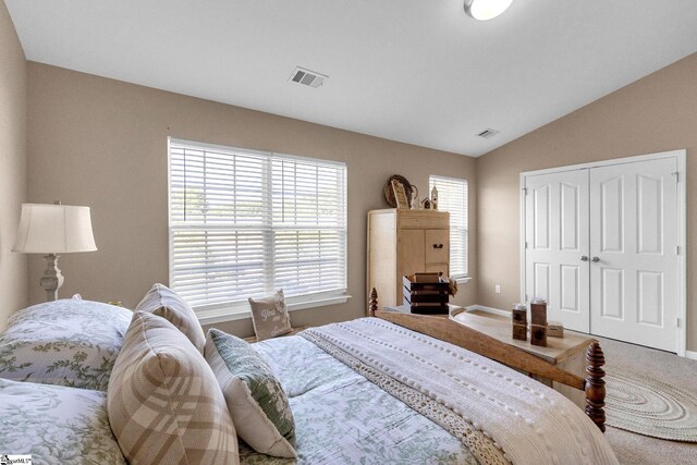 bedroom featuring a closet, vaulted ceiling, and carpet floors