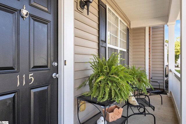 view of exterior entry with a porch