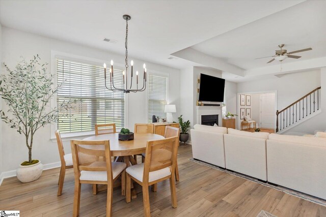 dining space featuring wood-type flooring and a chandelier