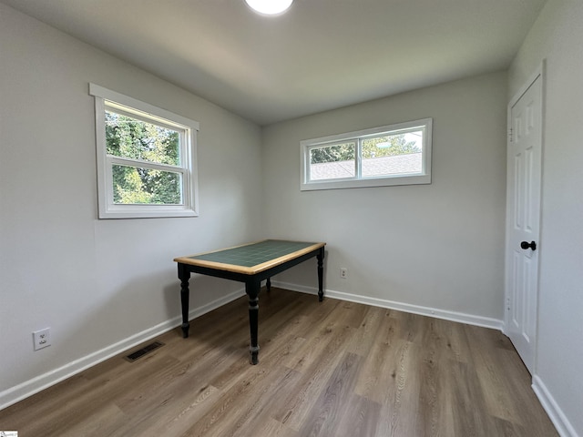 office area with a healthy amount of sunlight, visible vents, baseboards, and light wood finished floors