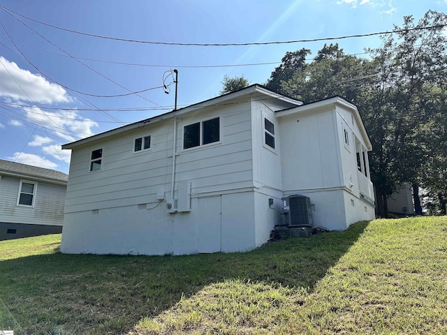 back of house featuring crawl space, a lawn, and central AC unit