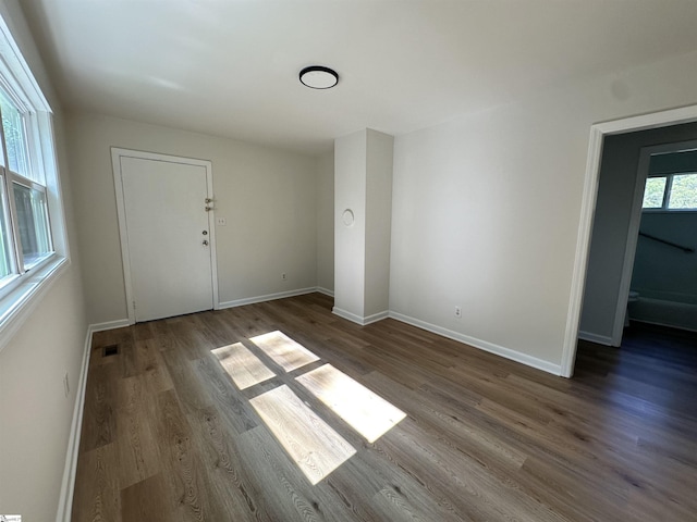 interior space with visible vents, baseboards, and wood finished floors