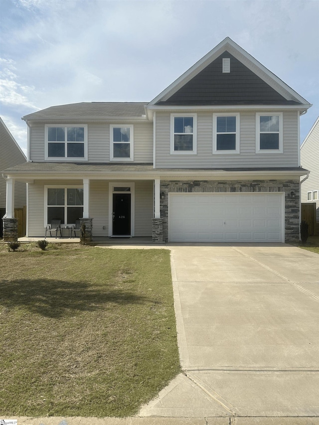 view of front of property featuring a garage and a front yard