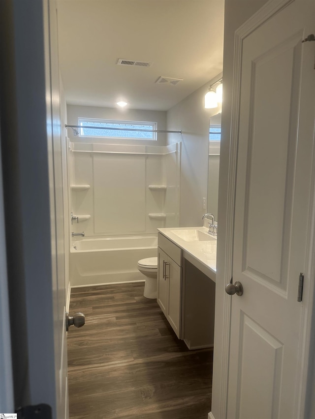 full bathroom with toilet, hardwood / wood-style flooring, shower / bathing tub combination, and vanity