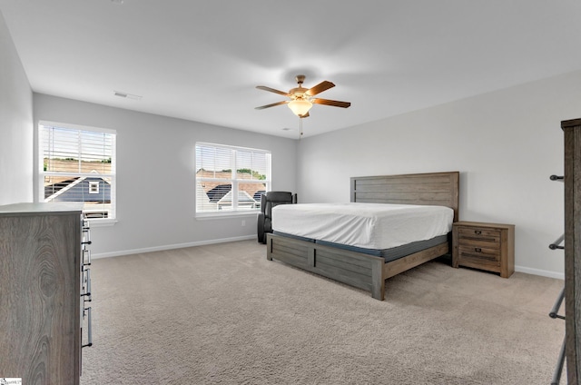 bedroom with visible vents, baseboards, and light colored carpet