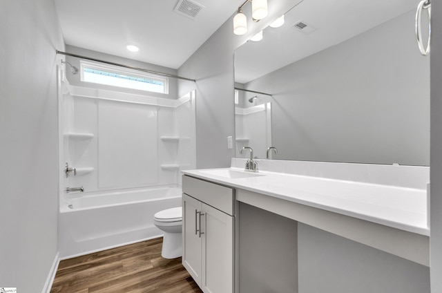 bathroom with wood finished floors, vanity, shower / bath combination, toilet, and visible vents
