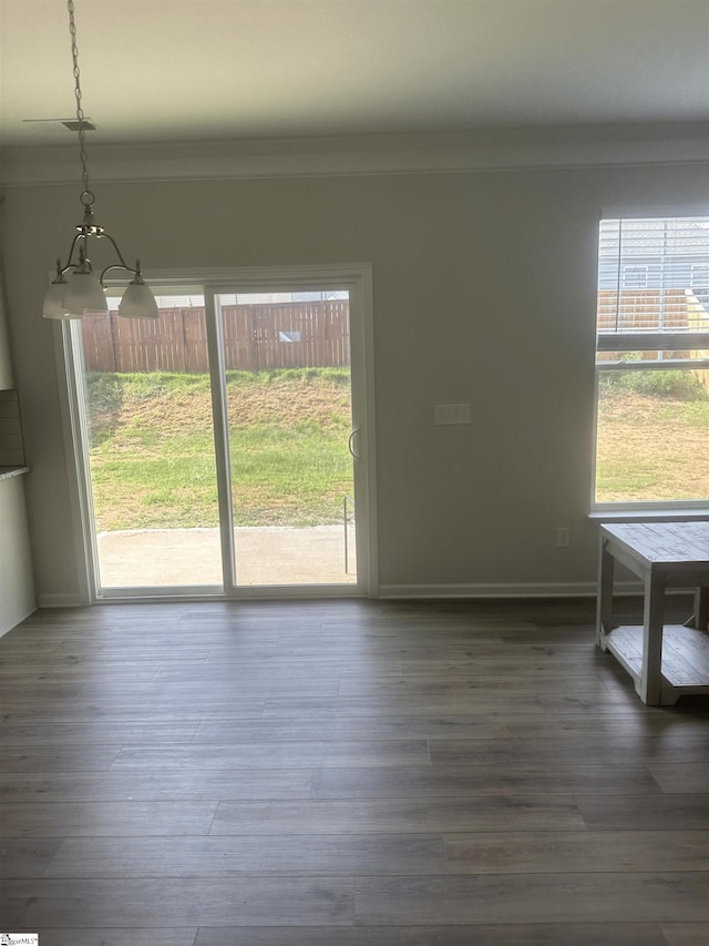 interior space featuring hardwood / wood-style flooring and a notable chandelier