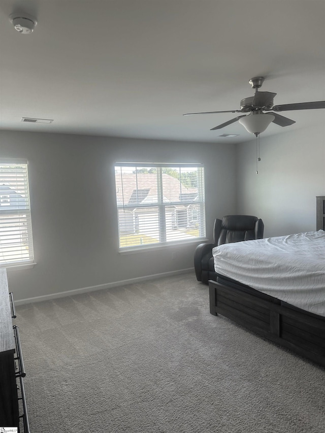 bedroom featuring ceiling fan and carpet