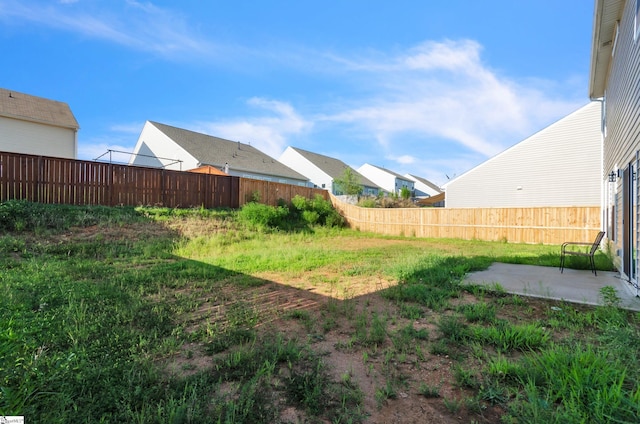 view of yard with a fenced backyard and a patio