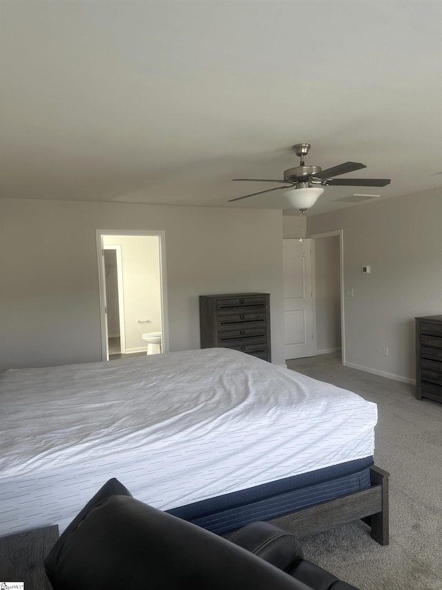 carpeted bedroom with ceiling fan and connected bathroom