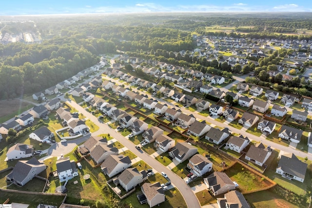 drone / aerial view with a residential view and a view of trees