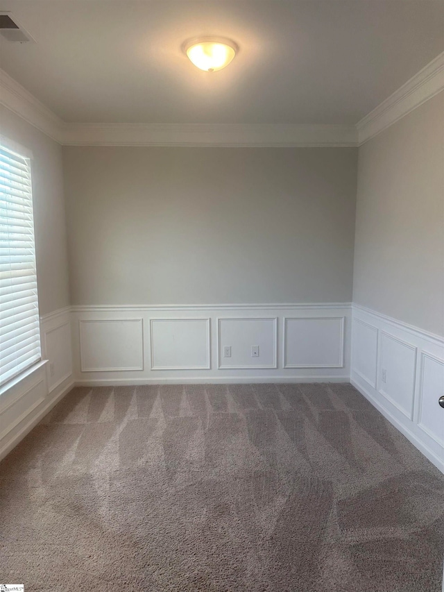 carpeted spare room featuring ornamental molding