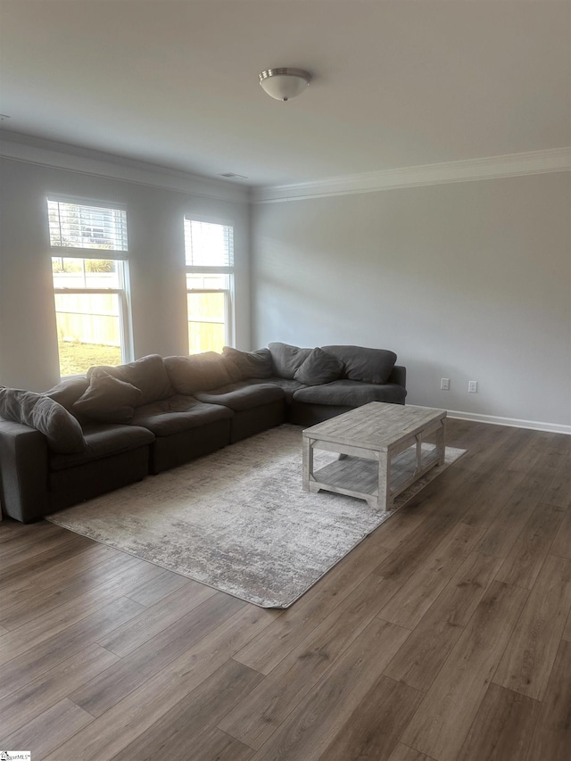 unfurnished living room featuring hardwood / wood-style flooring and ornamental molding