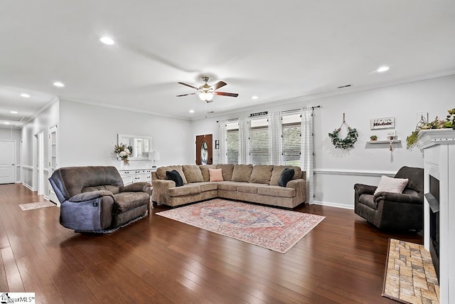 living room featuring ceiling fan, ornamental molding, and dark hardwood / wood-style flooring