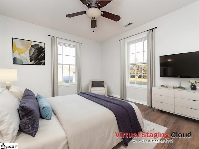 bedroom with ceiling fan and hardwood / wood-style flooring