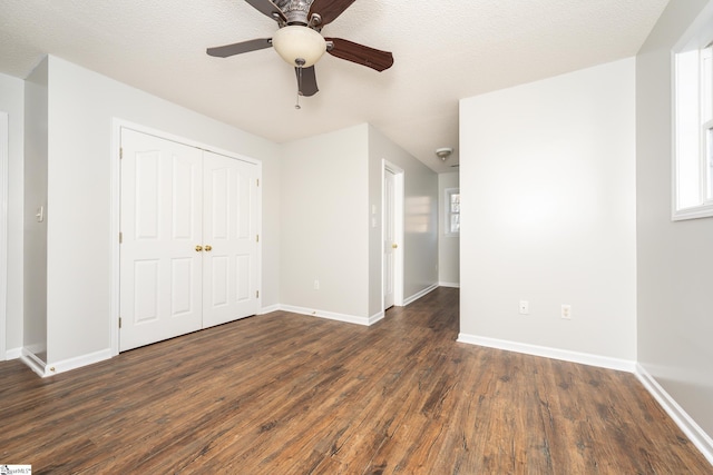 unfurnished bedroom with hardwood / wood-style floors, ceiling fan, a closet, and a textured ceiling