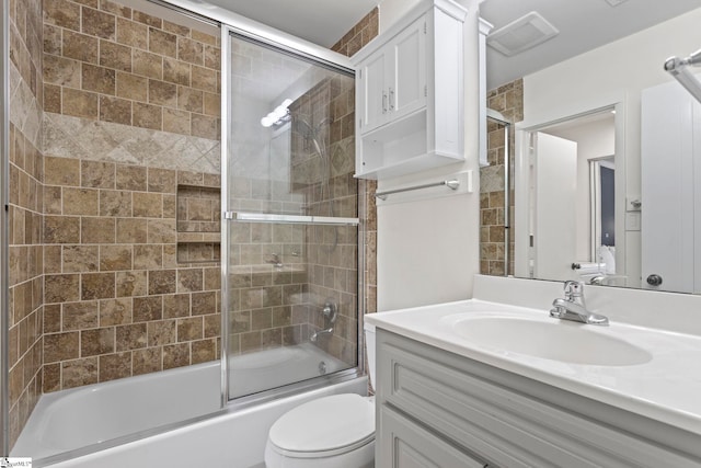 full bathroom with shower / bath combination with glass door, toilet, and vanity