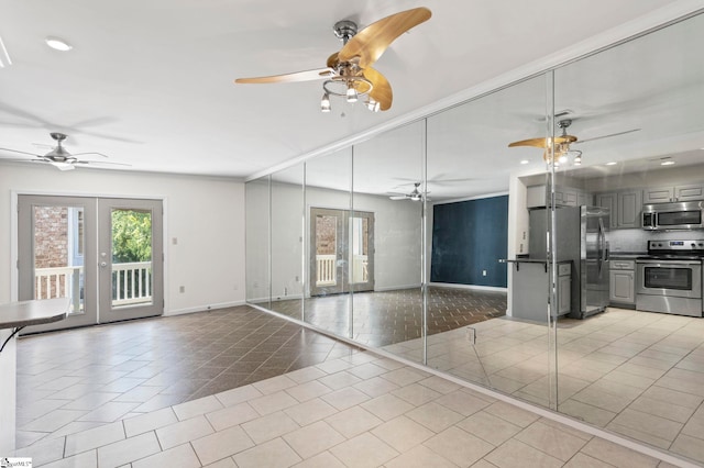 unfurnished living room featuring ceiling fan, light tile patterned flooring, and french doors