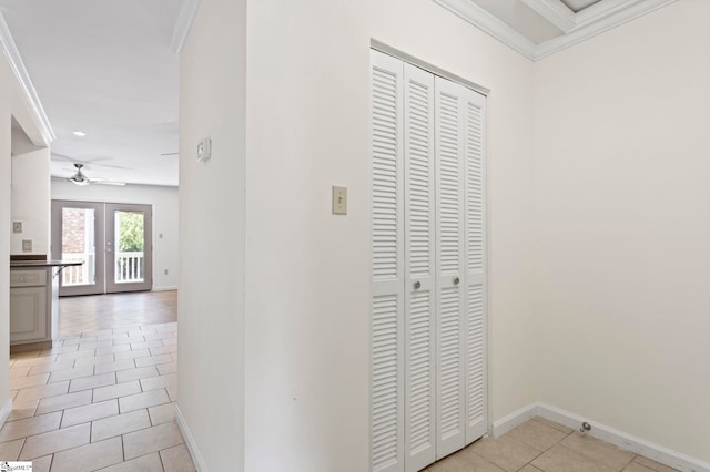 corridor featuring light tile patterned floors, crown molding, and french doors