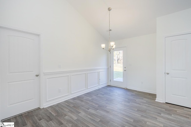 unfurnished room featuring a notable chandelier, light hardwood / wood-style floors, and high vaulted ceiling