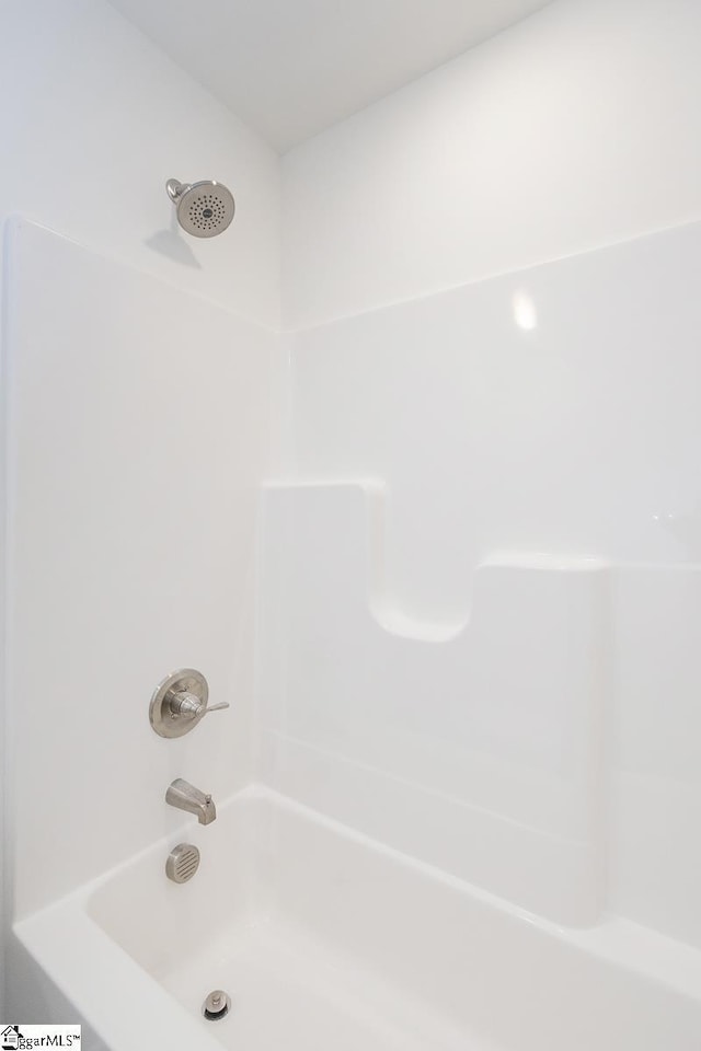 bathroom with bathing tub / shower combination