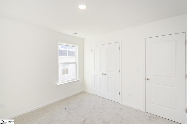 unfurnished bedroom with light colored carpet