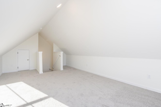 additional living space featuring light carpet and lofted ceiling