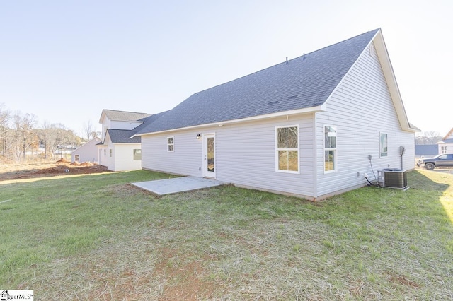 rear view of house with a lawn, cooling unit, and a patio