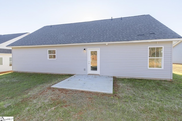 back of property featuring a yard and a patio