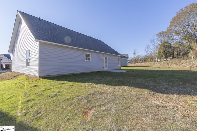 view of home's exterior with a lawn and a patio