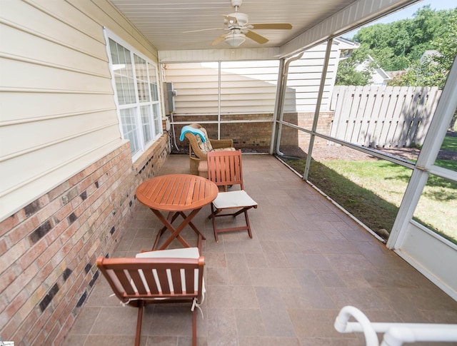 sunroom featuring ceiling fan