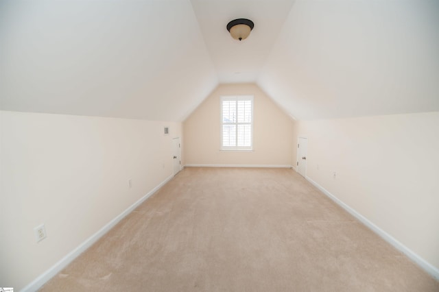 bonus room featuring light carpet and lofted ceiling