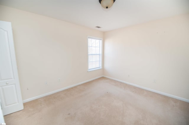 unfurnished room with light carpet